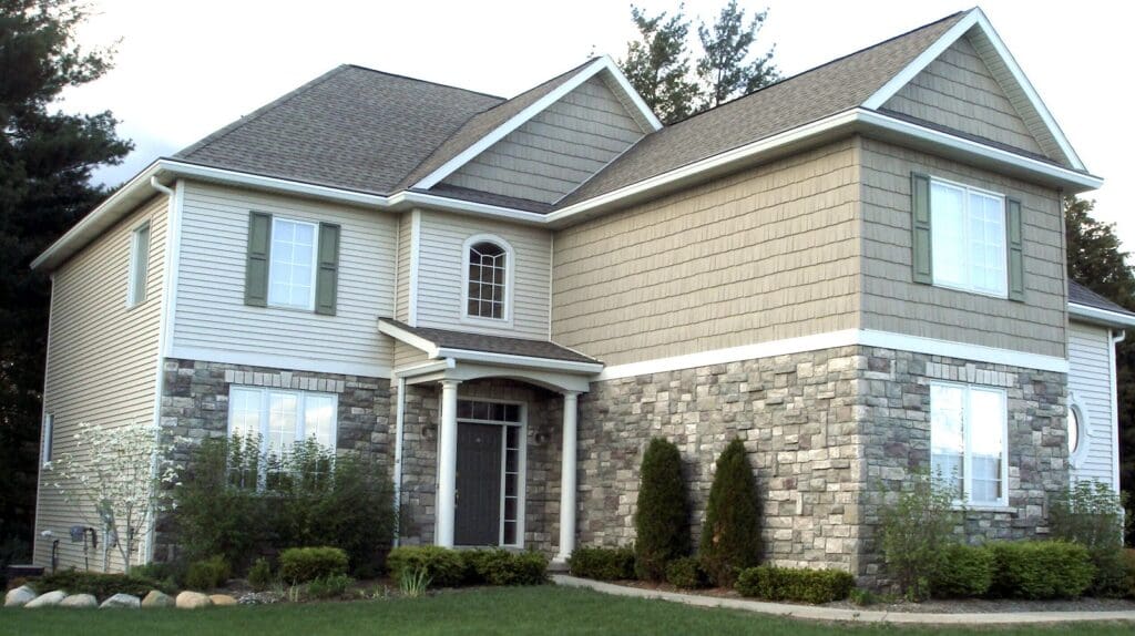 Earth tone house with white gutters